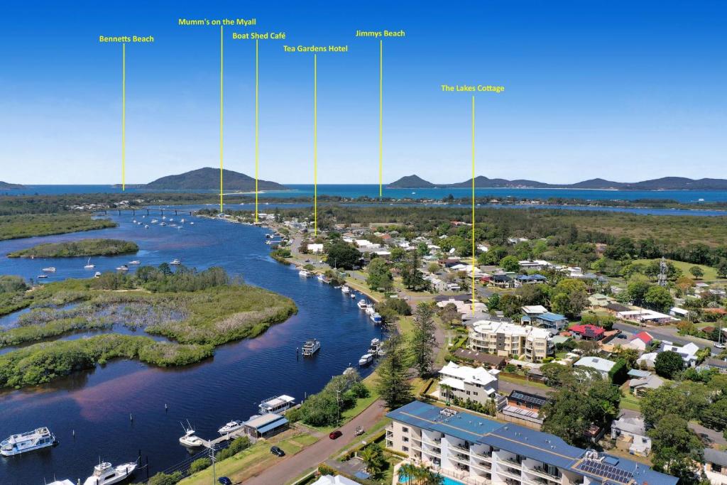 an aerial view of a river and a city at The Lakes Cottage in Tea Gardens