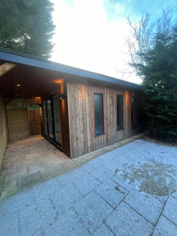 a house with a patio in front of it at The Summerhouse in Cheadle