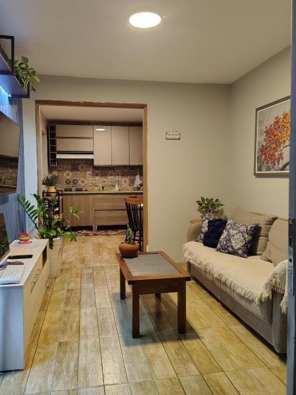 a living room with a couch and a table at Chico's House in Uruguaiana