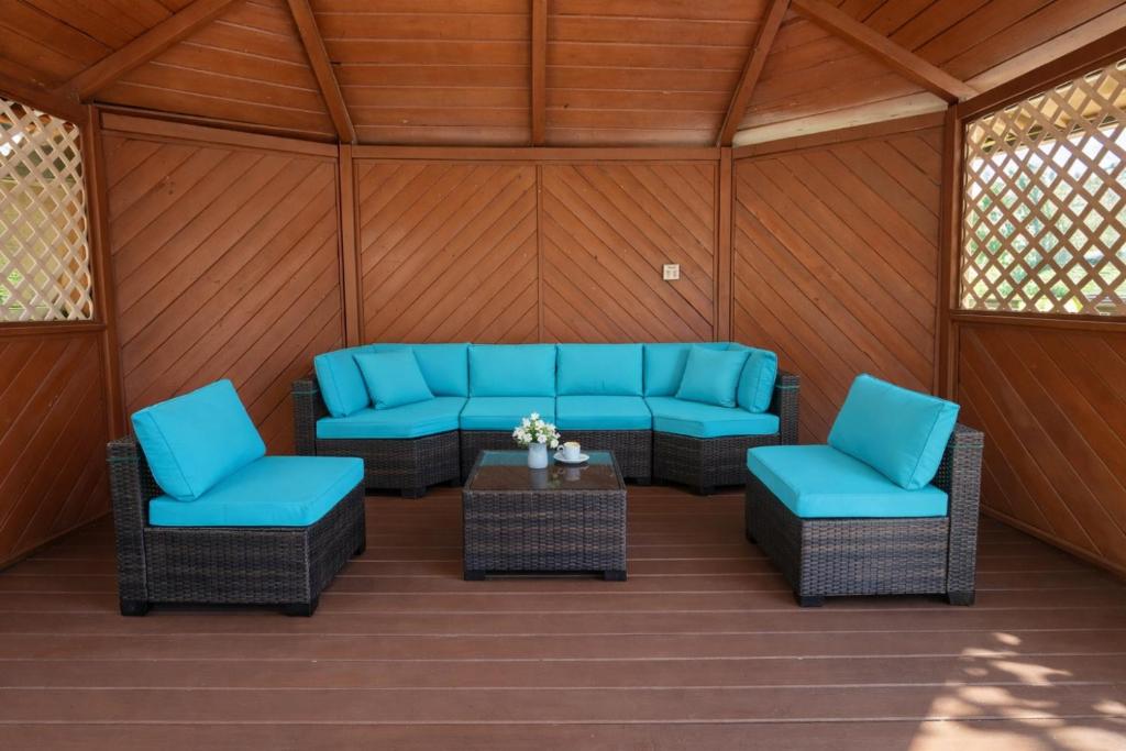 a screened porch with blue chairs and a table at Sierra Inn in Prescott