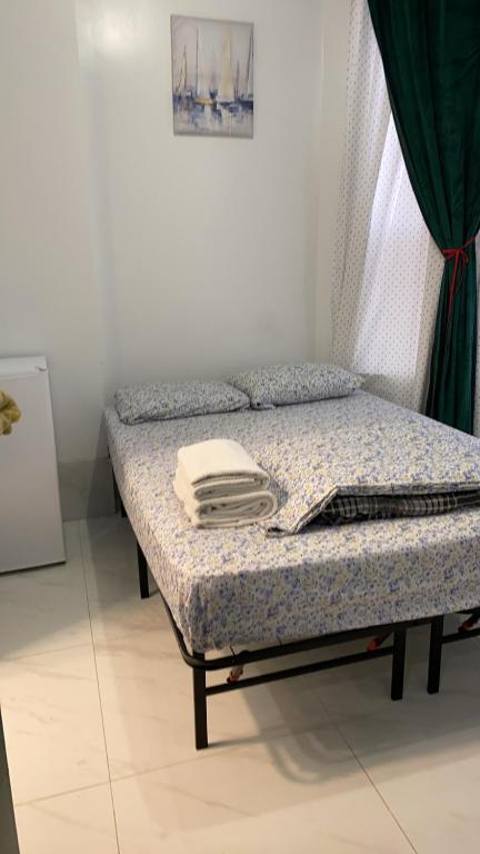 a bed in a room with a curtain and a bedvisor at 586 Hotel in Toronto