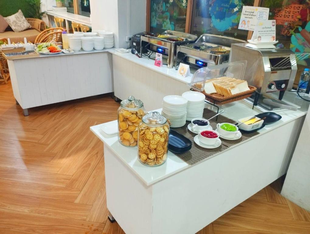 A self-service breakfast counter with hot dishes, toast, spreads and biscuits.