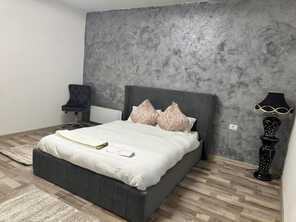 a bedroom with a bed with white sheets and pillows at Fabrizio house in Timişoara
