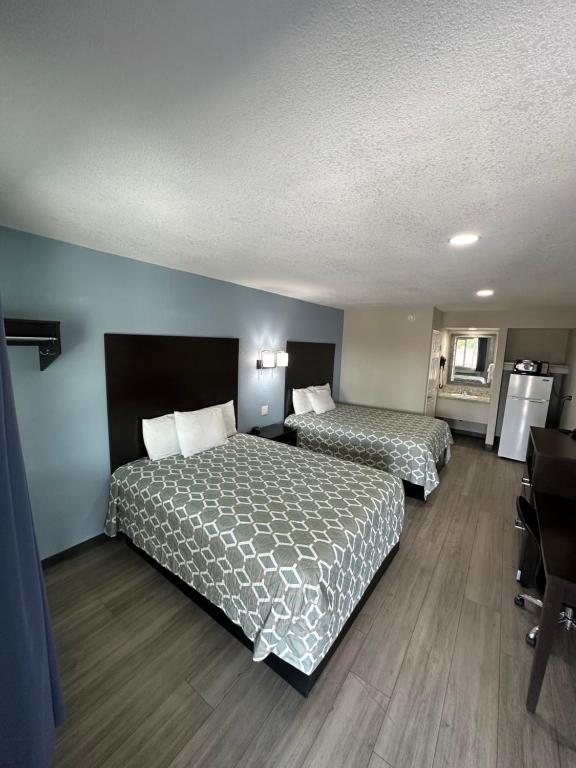 a hotel room with two beds and a desk at Gila Bend Lodge in Gila Bend