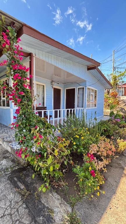 a blue house with flowers in front of it at Casa Vista Cafe in Cartago