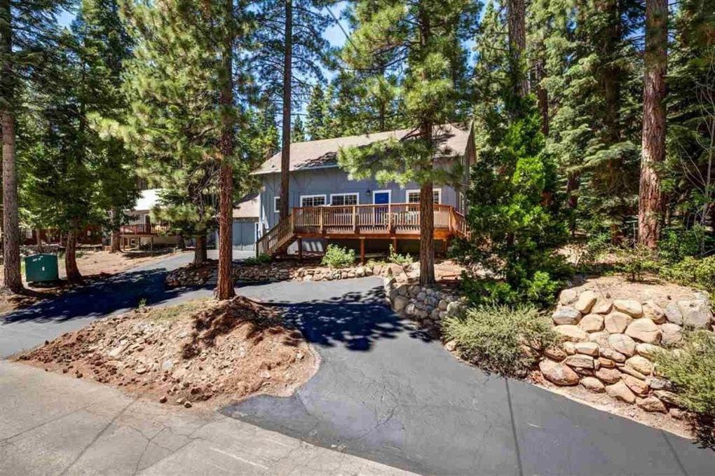a house with a deck in the woods at Carnelian Bay Lake House in Carnelian Bay