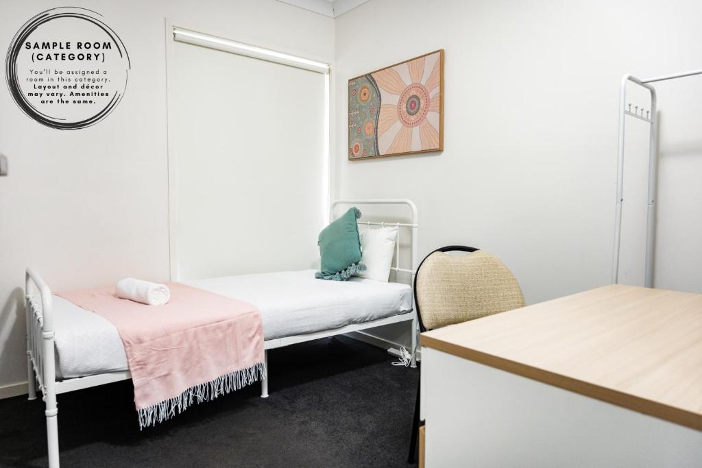 a room with two beds and a table at Serene Single Room - Convenient Location in Gregory Hills - Shared Bathroom in Gledswood Hills
