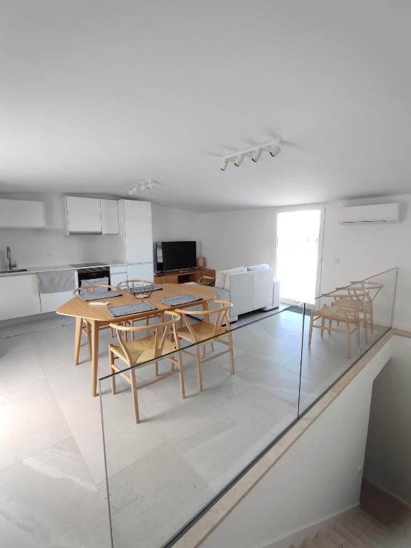a kitchen with a table and chairs in a room at Deluxe 2 Terraces River&Marina View Flat in Ferragudo