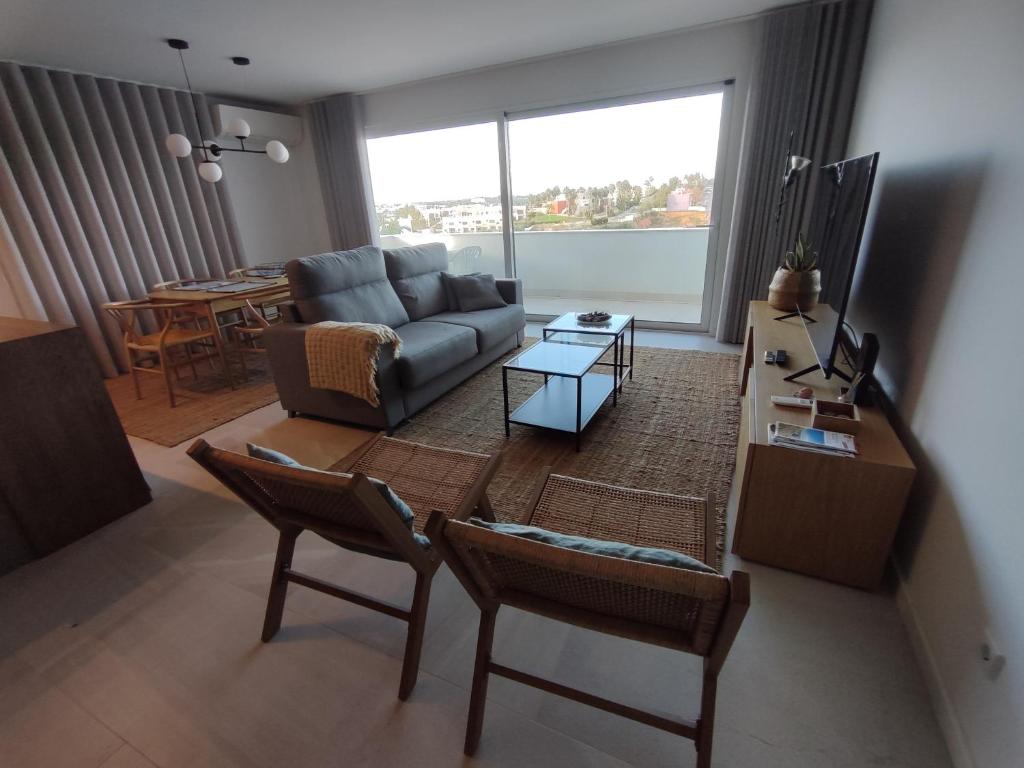 a living room with a couch and a table at Terrace Ferragudo River View Flat Super in Ferragudo