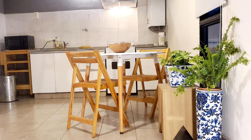 a kitchen with a table and chairs in a room at Departamento boutique céntrico in San Miguel de Tucumán