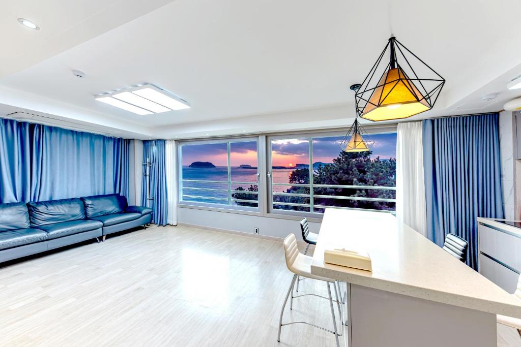 a living room with a view of the ocean at The Bay Jeju Resort in Seogwipo