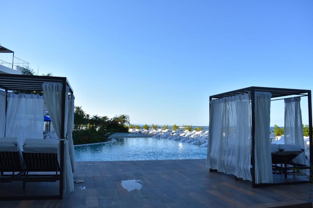 a patio with chairs and a swimming pool at MeliT in Las Terrenas