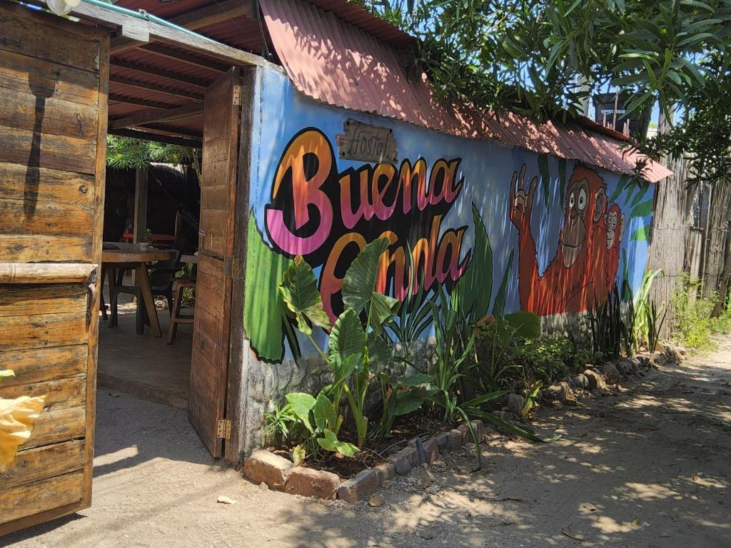 a building with a painting on the side of it at Hostal & Dormitorio Buena Onda in Palomino