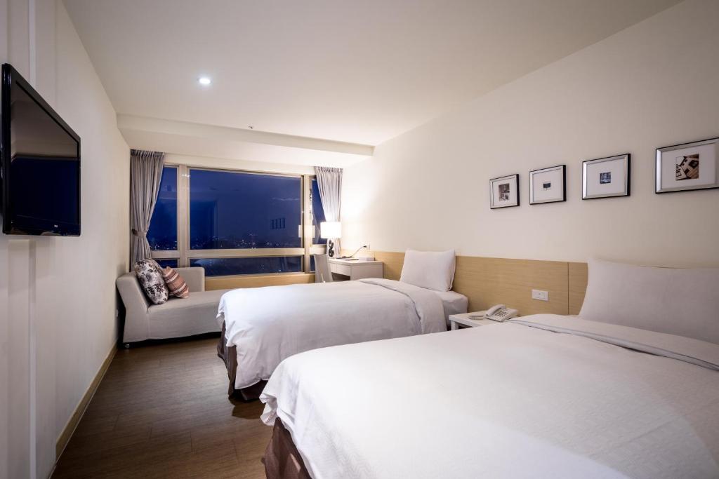 Postel nebo postele na pokoji v ubytování Wemeet Hotel Taipei