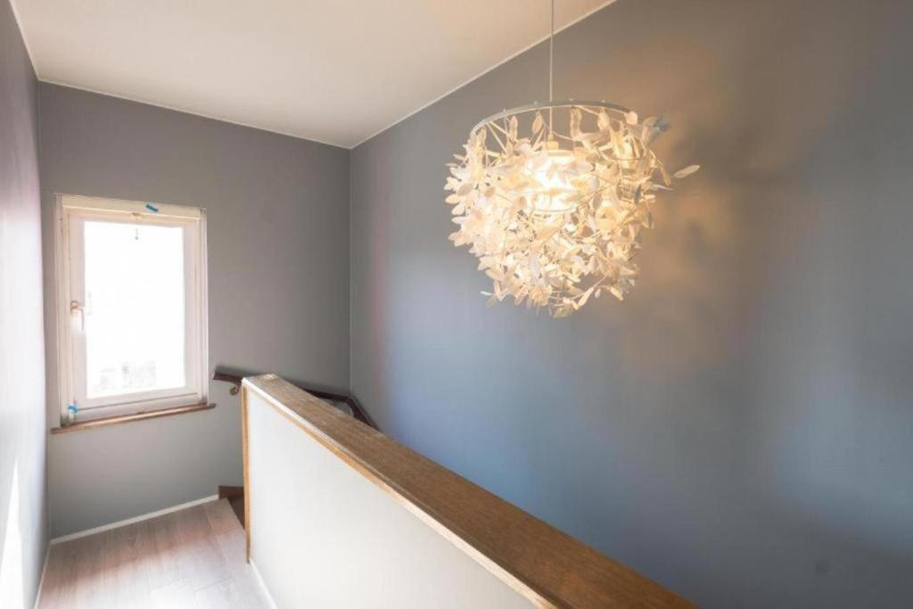 a hallway with a chandelier hanging from a wall at B cycle シングルルーム in Biei