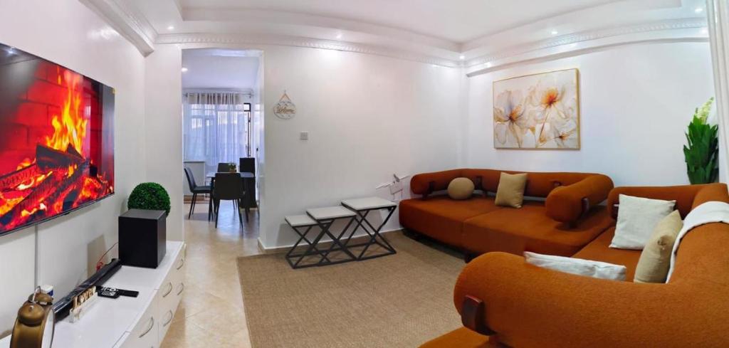 a living room with a couch and a tv at Fan Farm Stay in Munyu