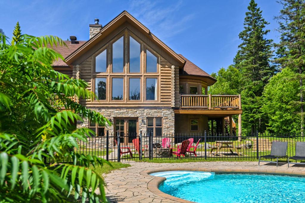 a house with a pool in front of it at Fiddler Lake Resort - Deer 73 in Mille-Isles