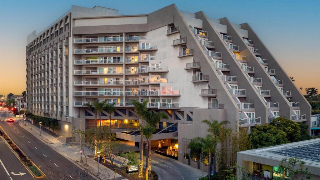 an apartment building on a city street at night at Hyatt Centric Delfina Santa Monica in Los Angeles