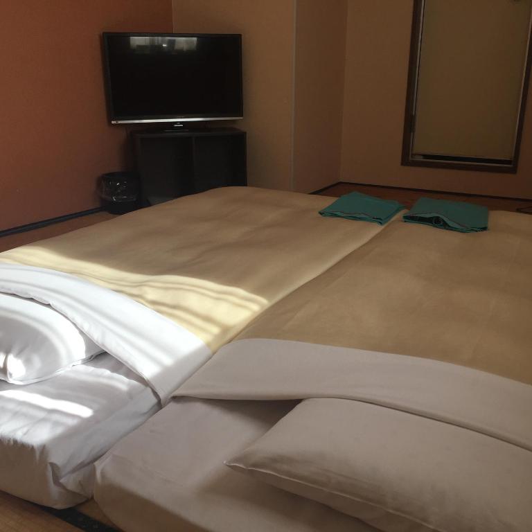 Postel nebo postele na pokoji v ubytování Hotel Niihama Hills