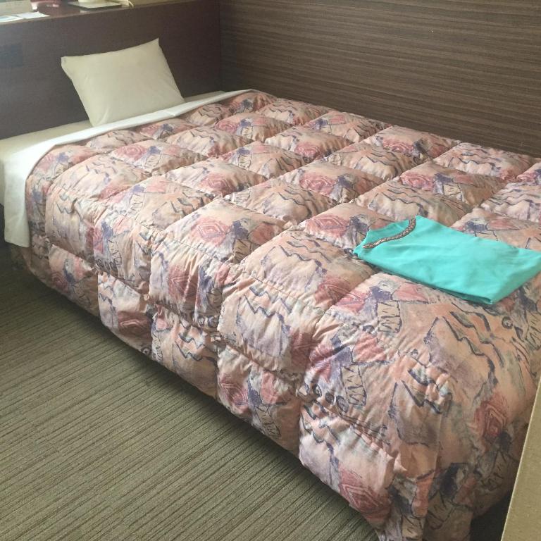 Postel nebo postele na pokoji v ubytování Hotel Niihama Hills