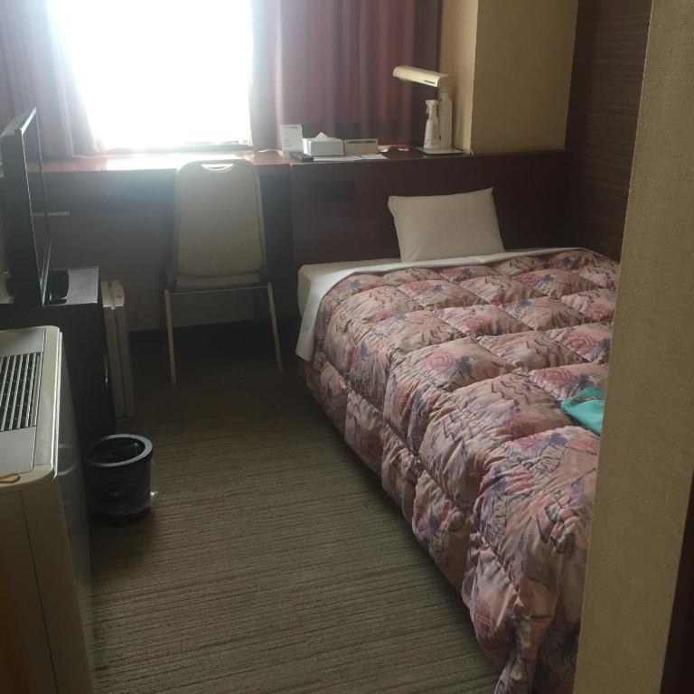 Postel nebo postele na pokoji v ubytování Hotel Niihama Hills