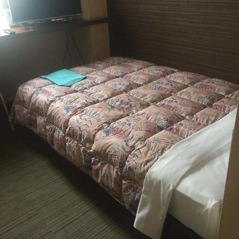 Postel nebo postele na pokoji v ubytování Hotel Niihama Hills