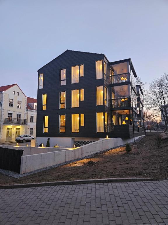 a large black building with its lights on at Pargi 21 Apartments in Tartu