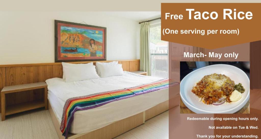 a room with a bed and a plate of food at LowPressure Surf Guesthouse in Donghe
