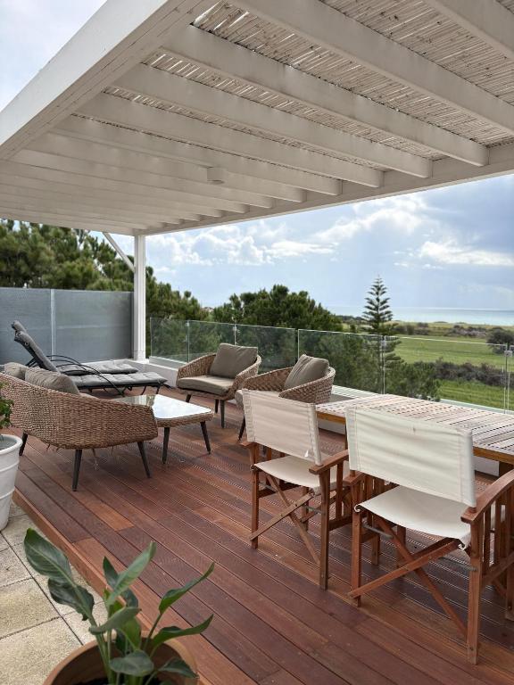 a patio with a table and chairs and an umbrella at Casa Vacanze Baciata in Ayios Theodhoros