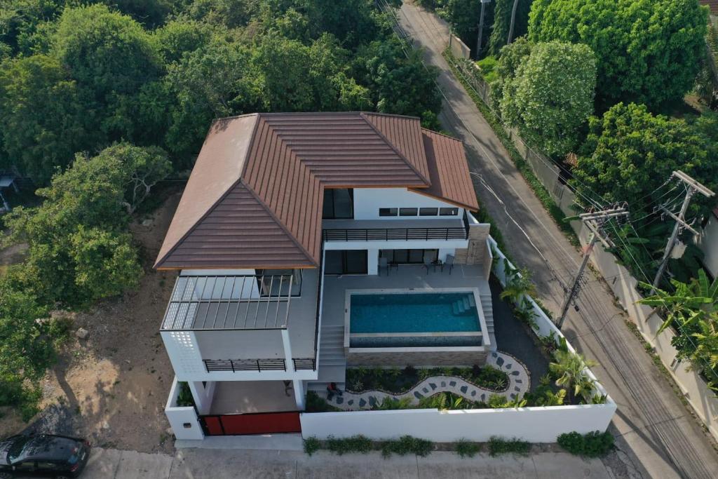 an aerial view of a house with a swimming pool at Rancho Relaxo Pool Villa in Ban Tai