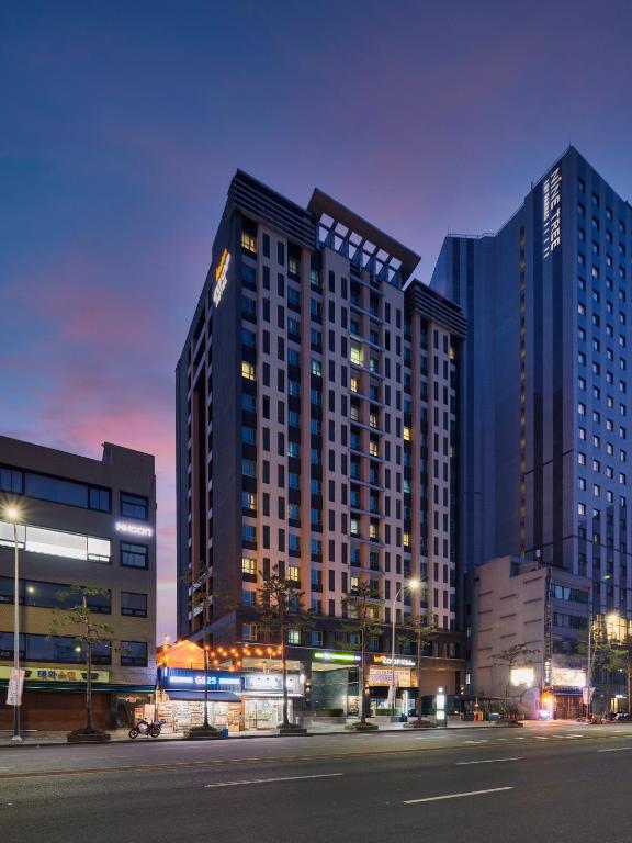 a large building in a city at night at Western Coop Hotel & Residence Dongdaemun in Seoul