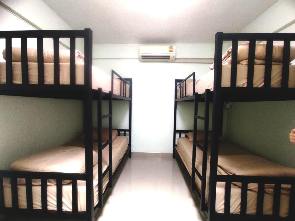 two sets of bunk beds in a room at 55 Hostel Soi Phetkasem 51 in Ban Tambon Bang Khae