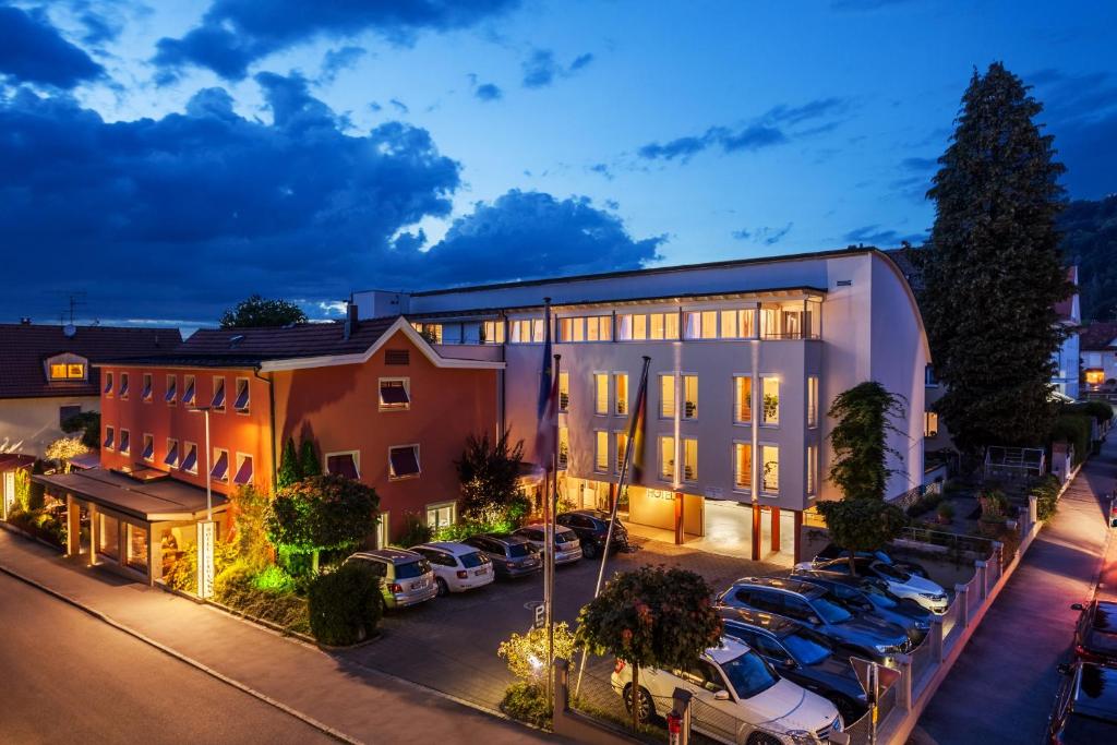 a building with cars parked in a parking lot at Hotel Germania in Bregenz