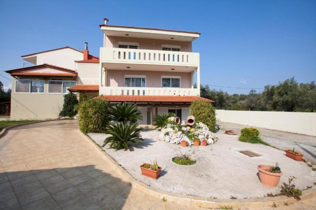 a house with a courtyard in front of it at Natural Quiet Accommodation 2 - Faliraki in Kalithies