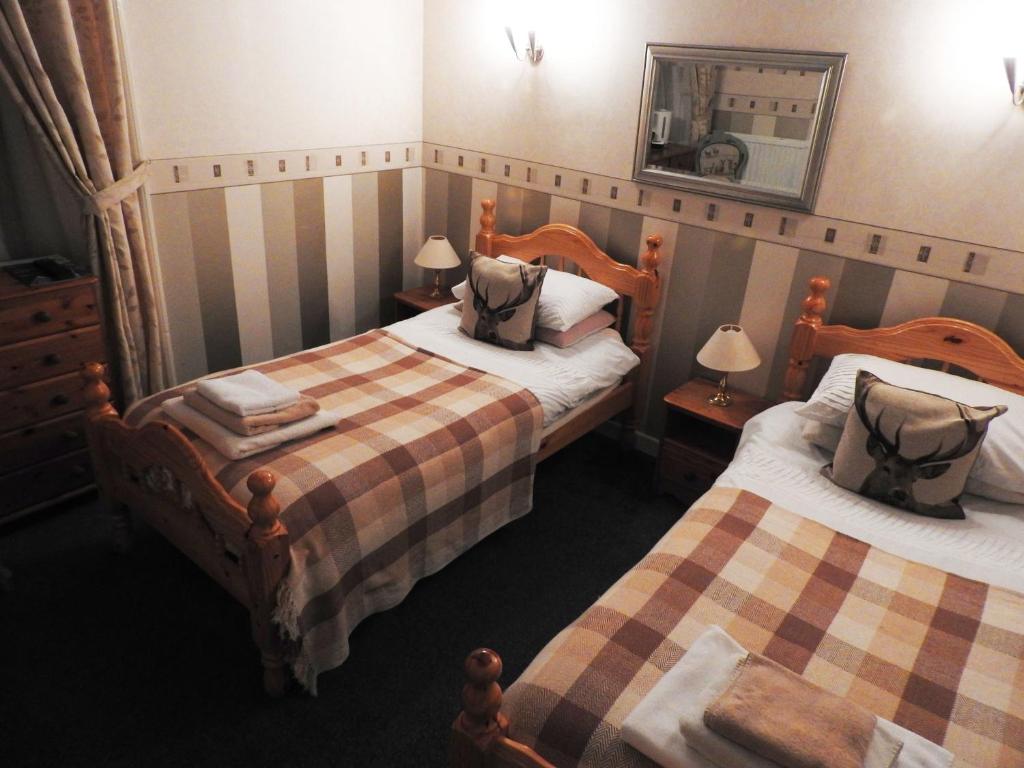 
A bed or beds in a room at The Stag Head Hotel
