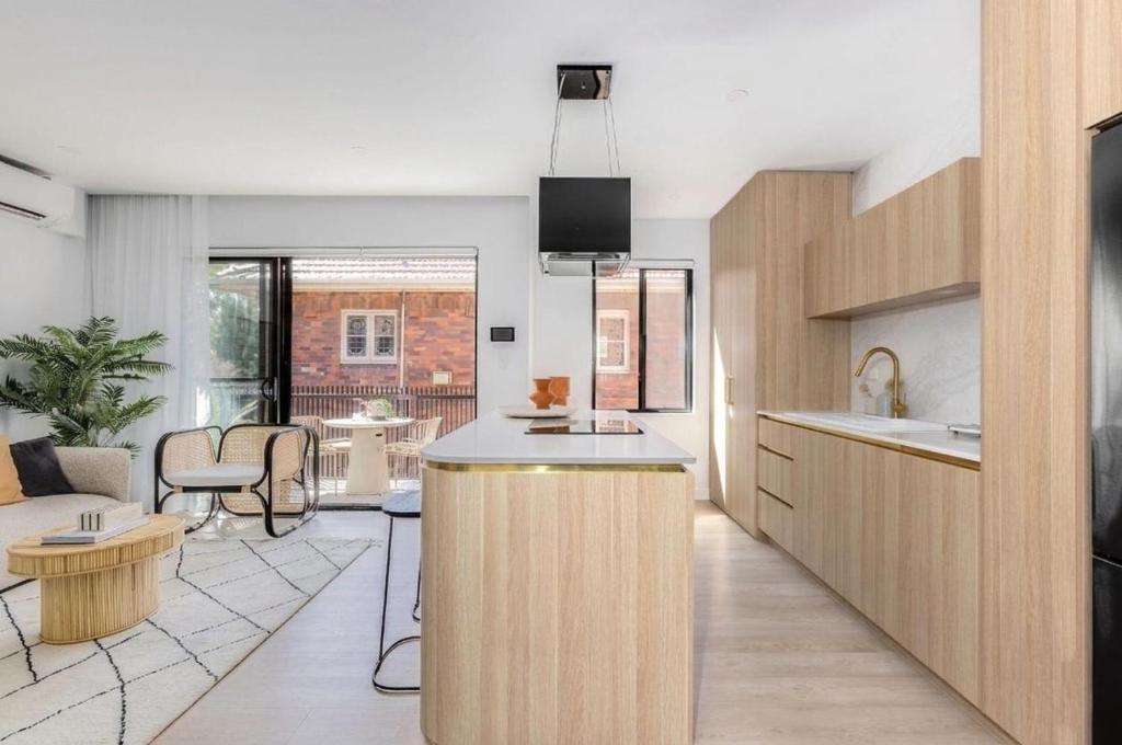 a kitchen and living room with a couch and a table at Medusa Bondi in Sydney