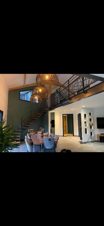 a living room with a table and a staircase at Aloha House 88 in Le Val-dʼAjol