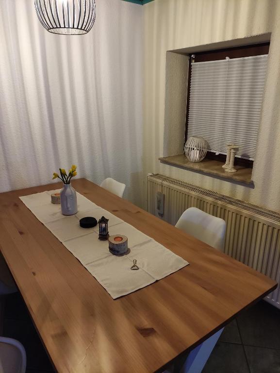 a wooden table with a table cloth on top of it at Ferienwohnung Mandy in Morsleben