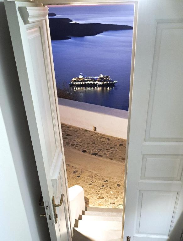an open door with a view of the ocean at Yposkafo Suites - Studio - Santorini in Fira