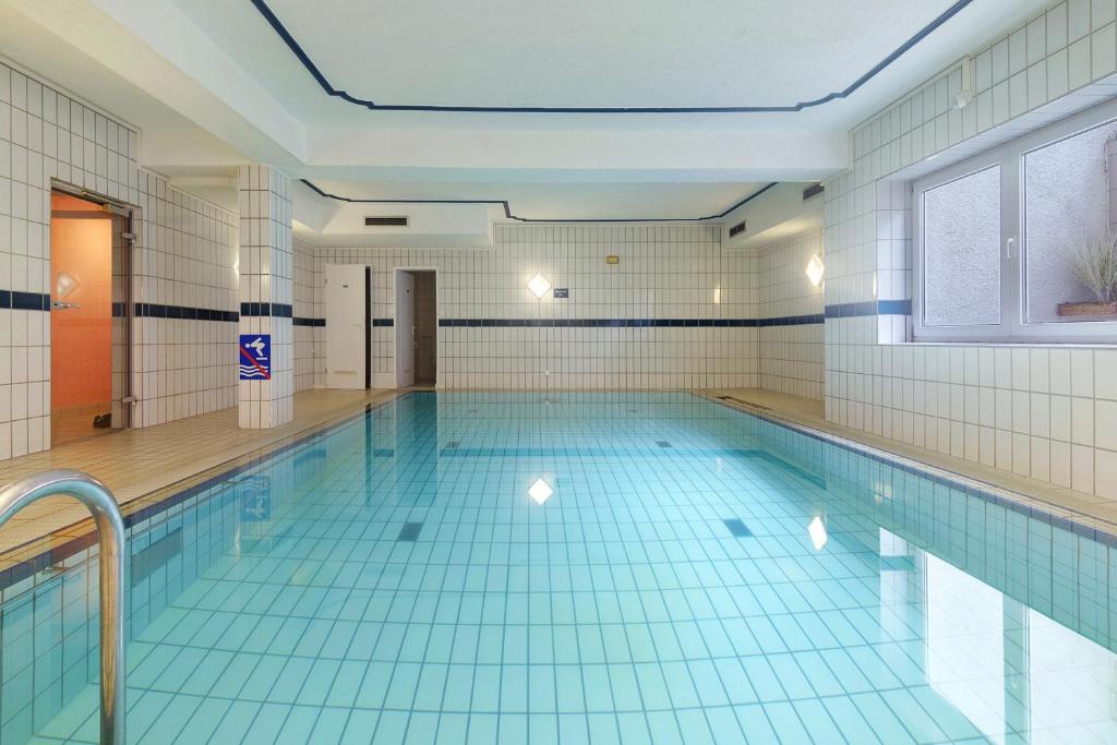 a large swimming pool with blue tiles on the floor at Ferienidyll Zwiesel in Zwiesel