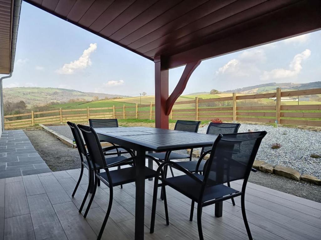 a black table and chairs on a patio with a view at Eyhegaya in Ordiarp