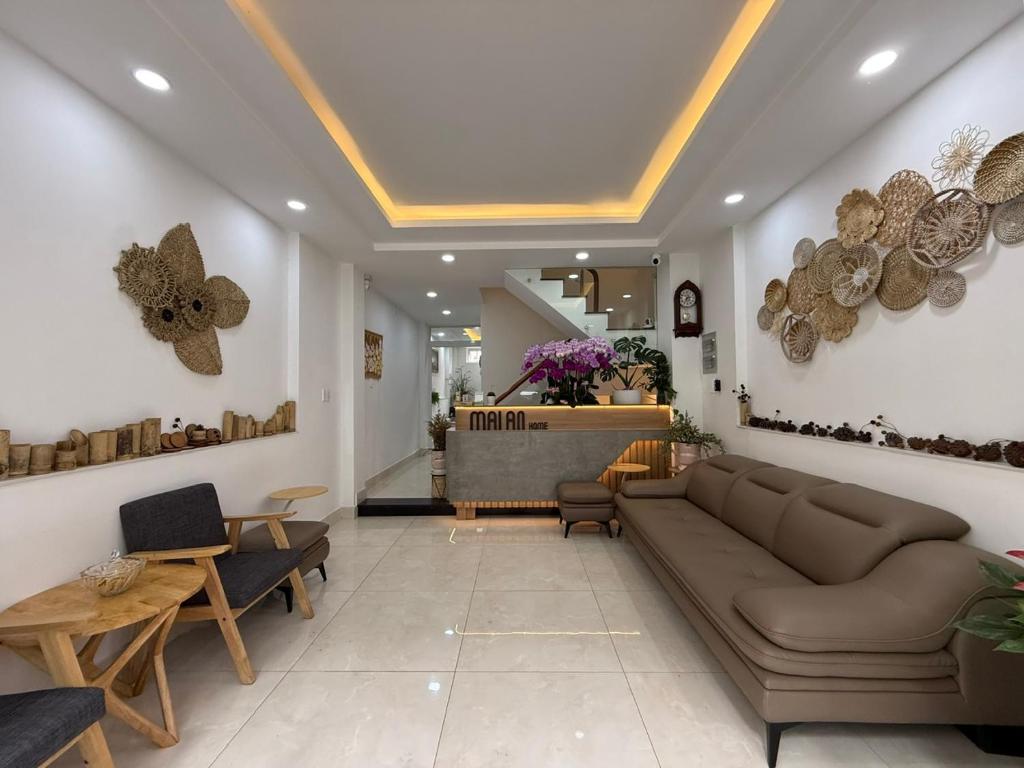 a living room with a couch and a table at Mai An Home in Da Lat