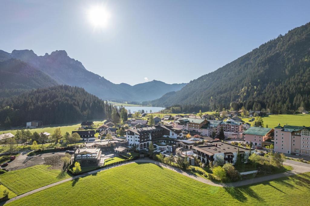 an aerial view of a resort in the mountains at Hotel Tyrol am Haldensee in Haldensee