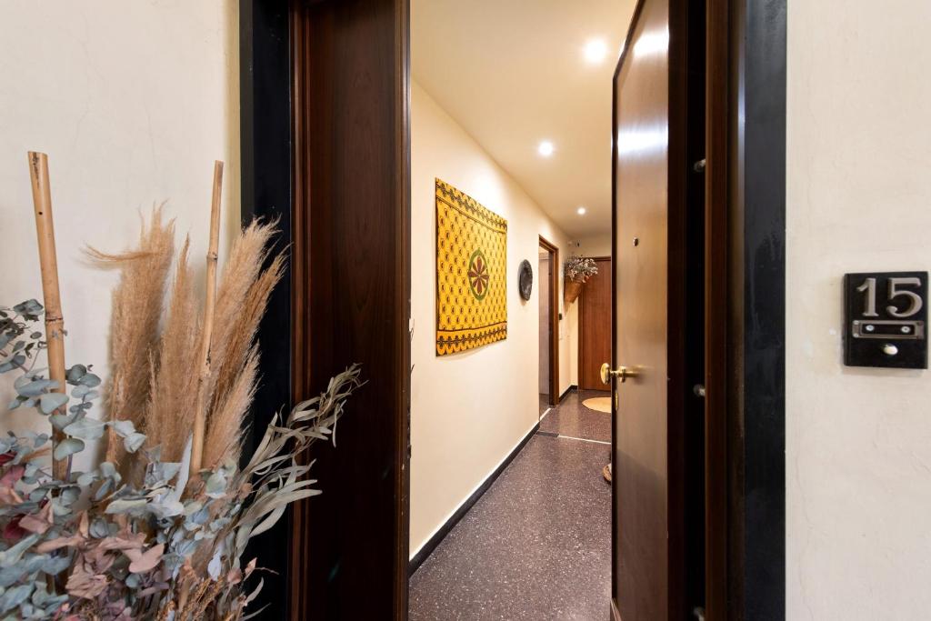 a hallway with a door with a number sign and a plant at Case Sole e Luna in Genoa