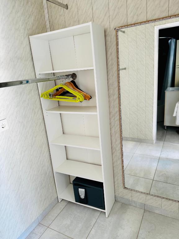 a white cabinet with a mirror in a bathroom at Villa Sila in Novalja