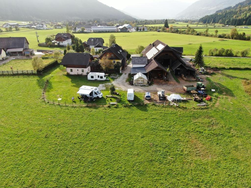 an aerial view of a farm with vehicles parked in a field at Meissnitzerhof in Sankt Margarethen im Lungau