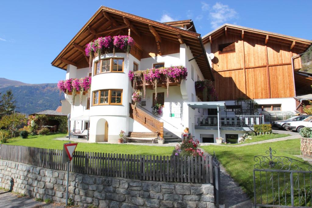 a house with flowers on the balconies at Apartment Schullehrer in Kauns