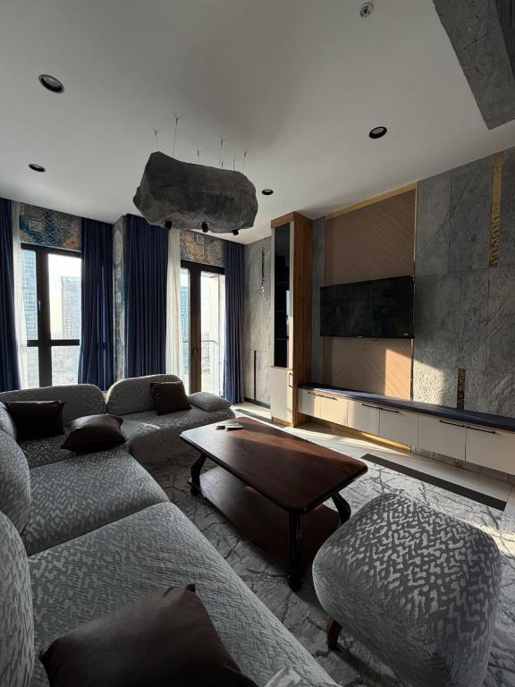 a living room with a couch and a table at NEST ONE - Floor 15 in Tashkent