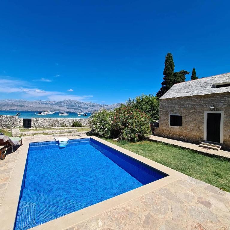 a swimming pool in the yard of a house at Vila Lovrečina in Postira