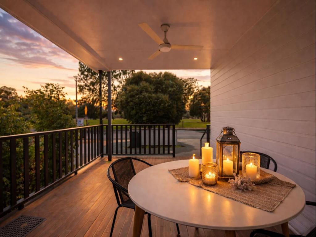 a table on a deck with candles on it at Golfside Haven 2 Bedroom Duplex with Golf Course in Rosslea